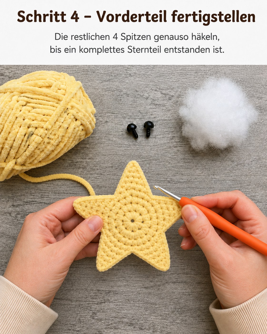 Fertig gehäkeltes fünfzackiges Sternvorderteil aus gelbem Plüschgarn liegt flach auf dem Tisch